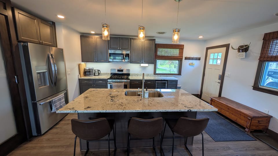 Updated kitchen with beautiful stainless steel appliances & island seating