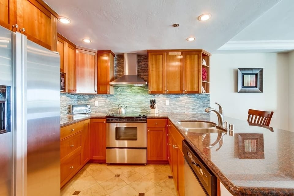 Kitchen fully equipped for meals at home with granite countertops, stainless steel appliances including a dishwasher, and recessed lighting