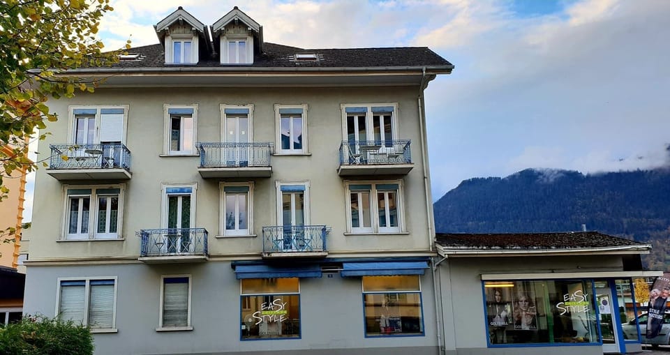 Outside building.  Your apartment is on the 1st floor with the 2 balconies