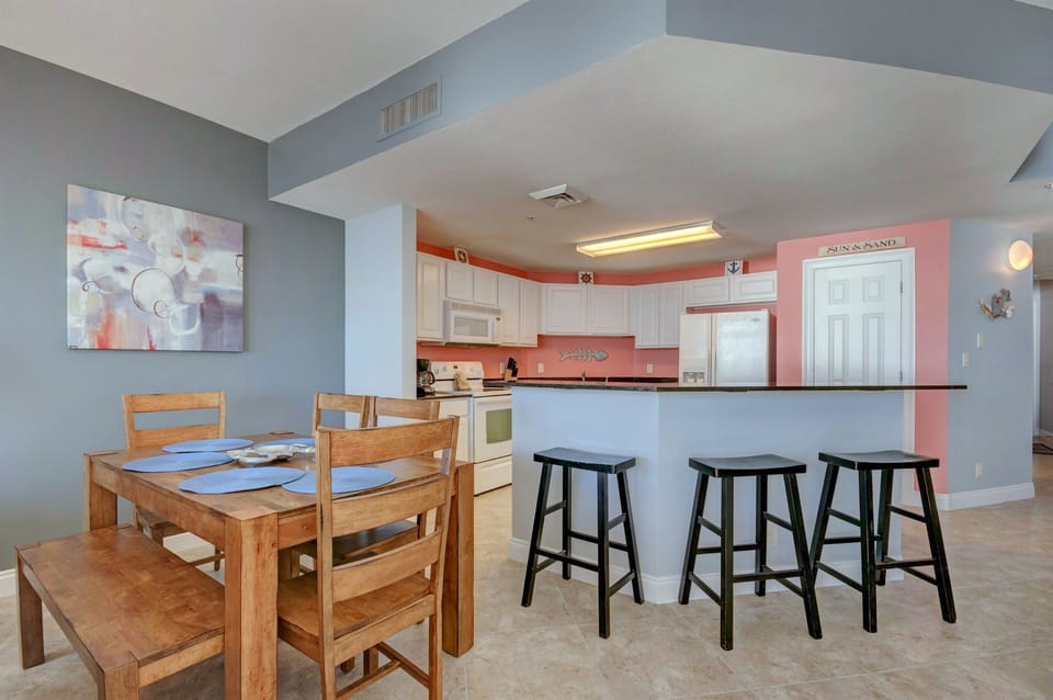 Dining Area - Gather loved ones around this cozy dining space for four, where each meal is elevated by serene beach views and natural light.