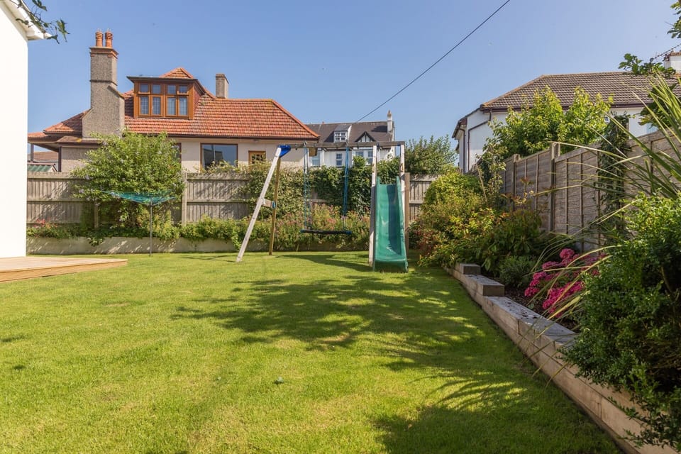 Garden play area with swing and slide at Rock House Bude