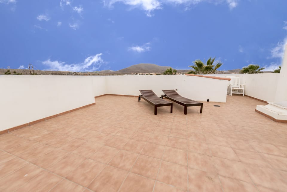 Rooftop Solarium - sunbeds and eating table.  A secluded sun trap with views !