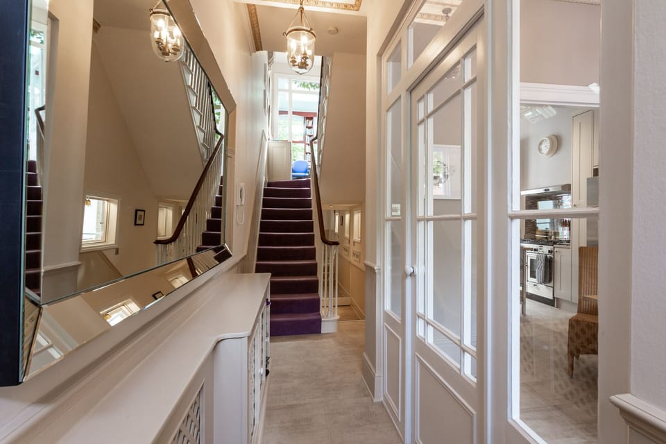 Front entrance hall - looking up the stairs.  Dining room on the right