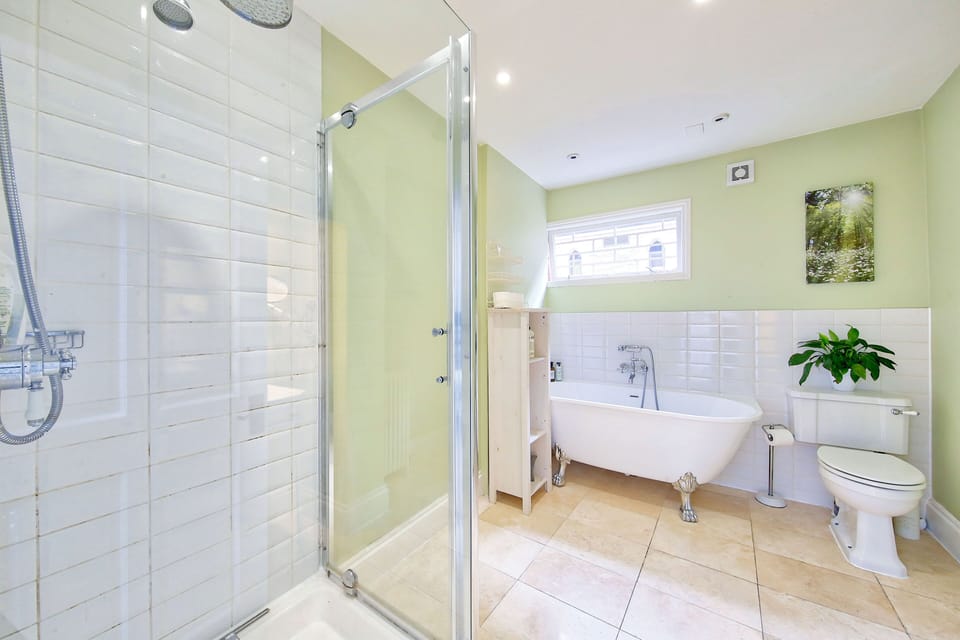 Bathroom with bath and separate shower unit