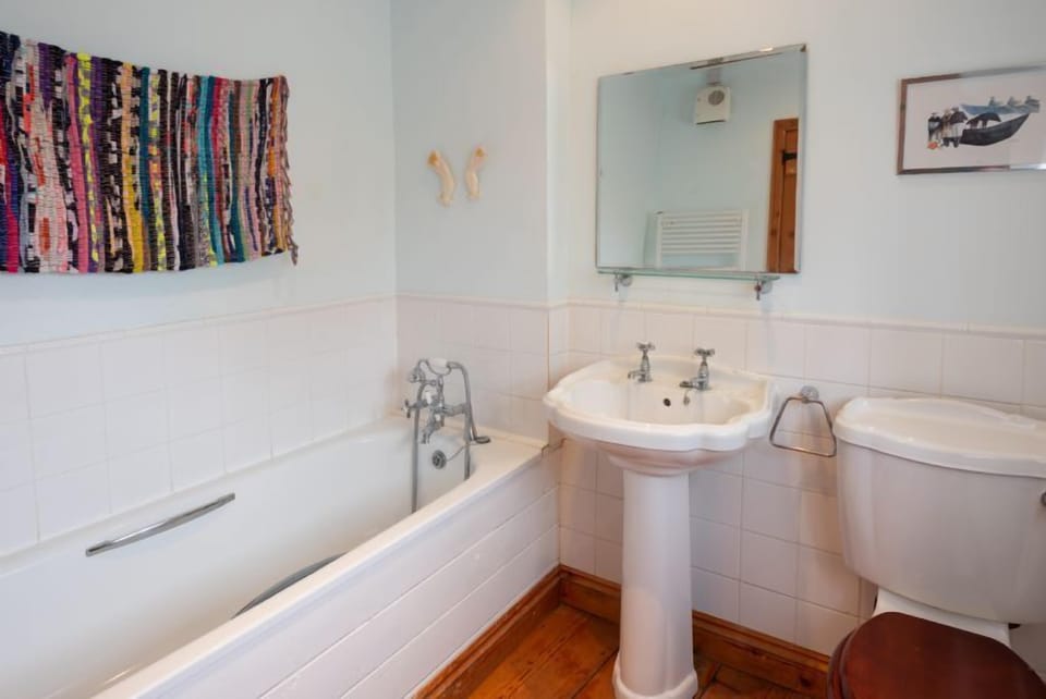 Annexe bathroom has bath and hand-held shower