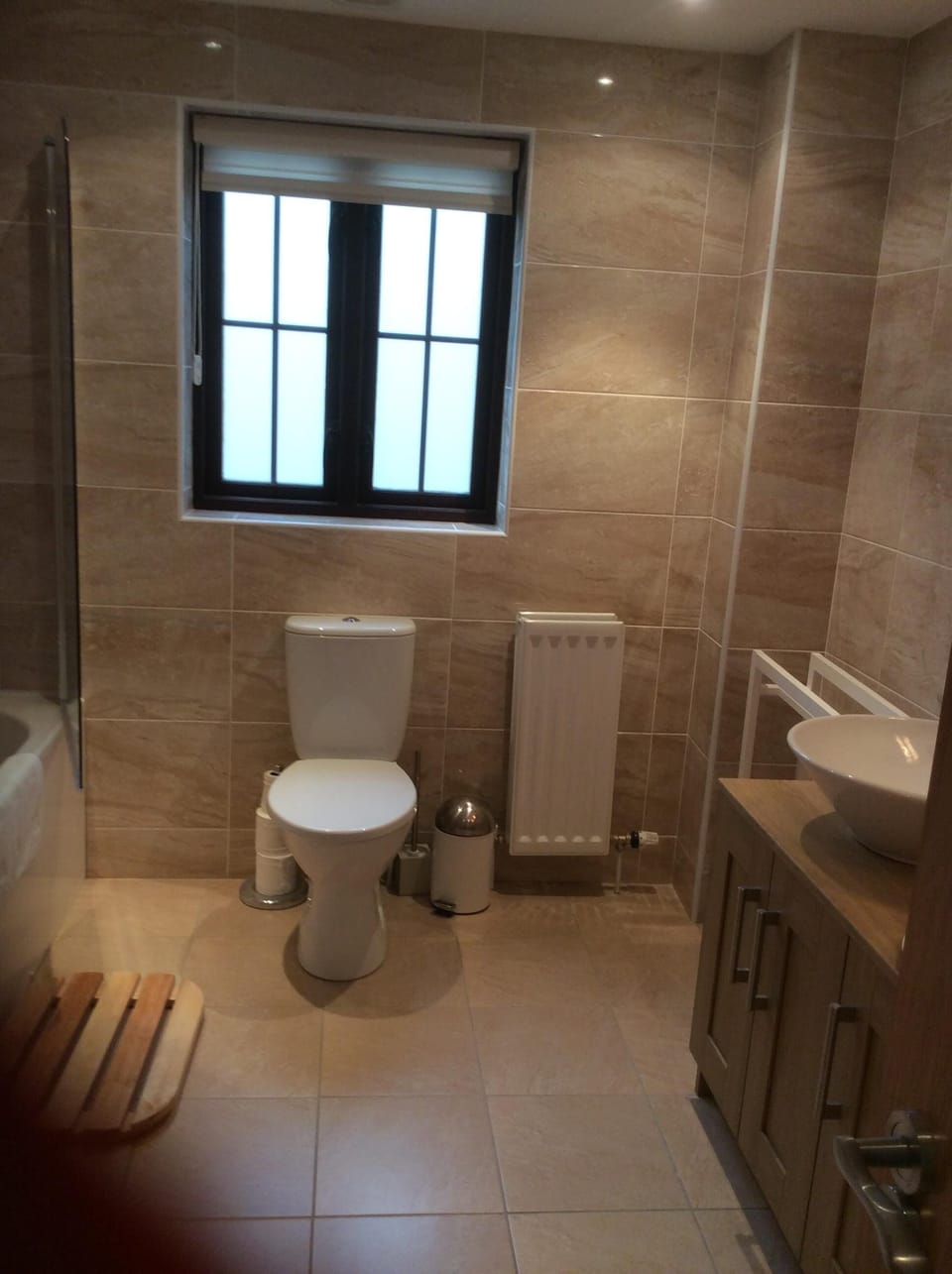 Family bathroom with bath, and double sinks and built in unit.