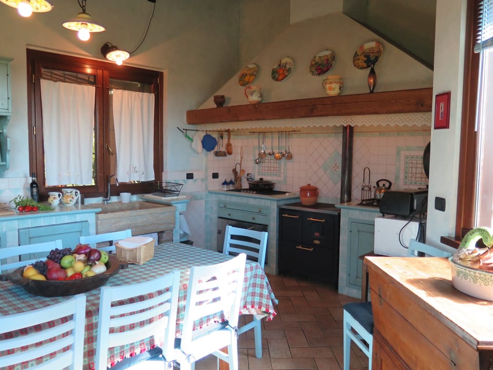 The cooking area with traditional gas stove and a wood burning stove