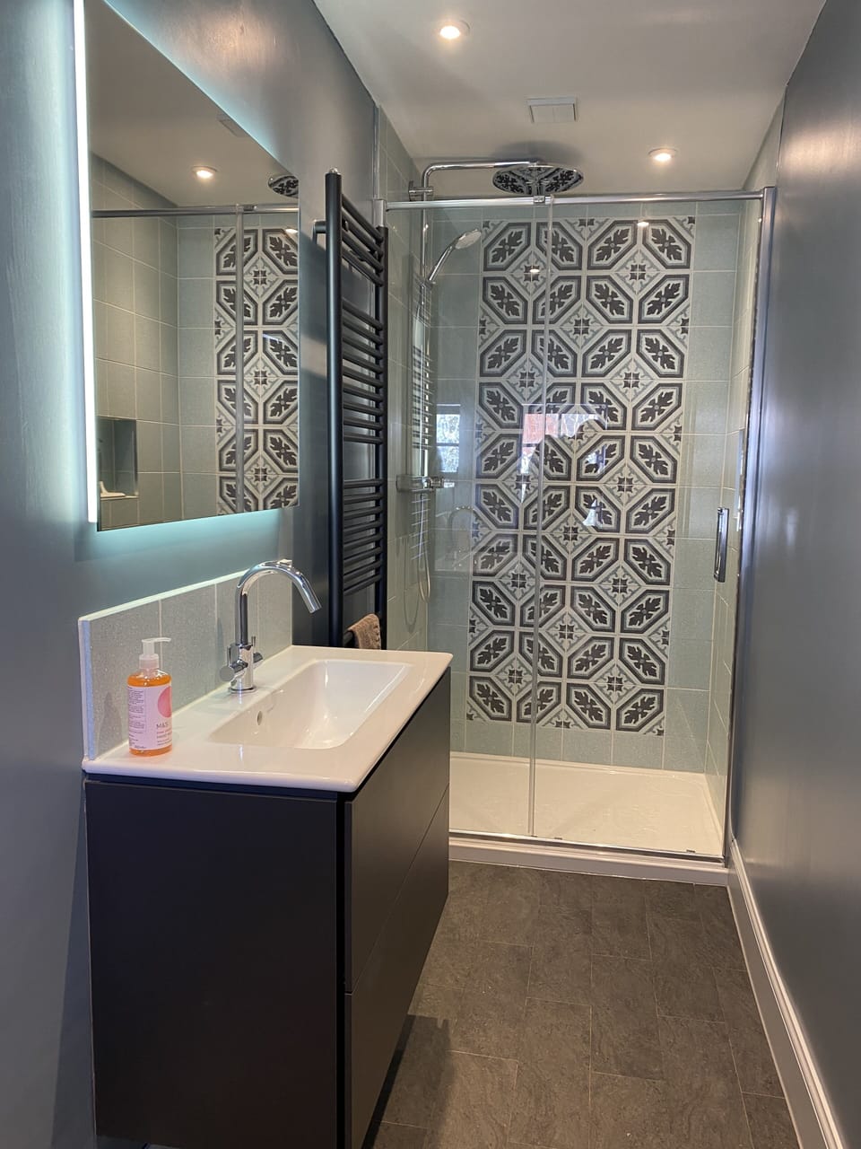 Bathroom includes rain shower and heated towel rail.