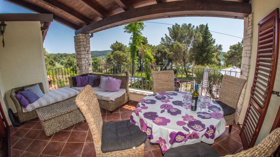 verandah outside kitchen overlooking pool and sea