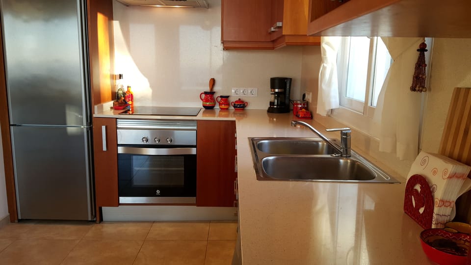 Fully equipped kitchen with stove, oven, microwave and dishwasher.