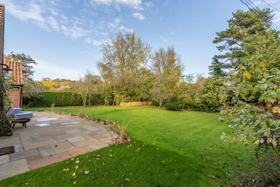 Waterside, Wiveton: Lawned garden with patio