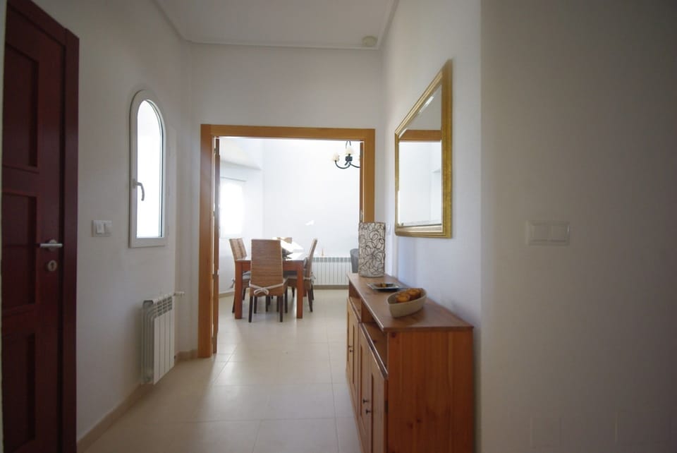 entrance hallway leading to inside dining area & high ceiling lounge