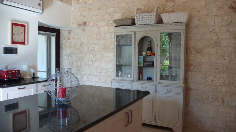 Second view of main kitchen with door to covered veranda.