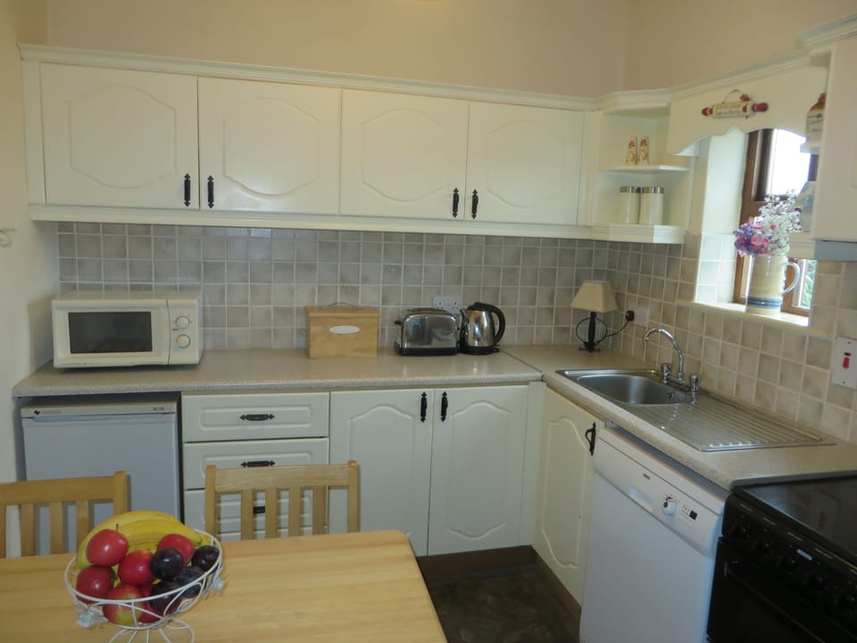 Fully equipped kitchen with cooker, fridge, microwave, kettle and toaster