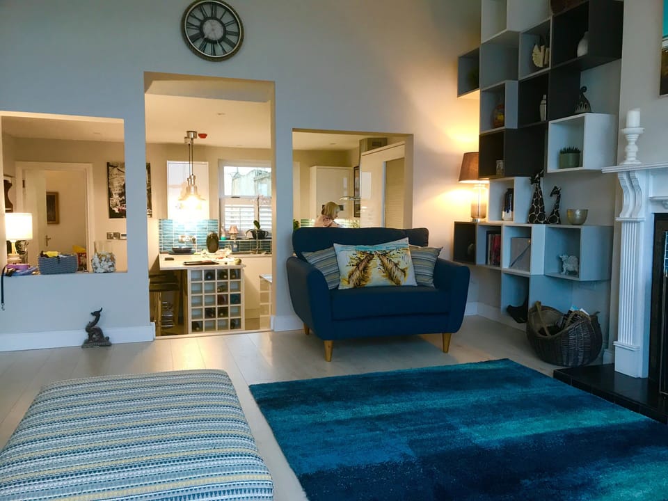 For some the wine rack is the best view of all. Love seat with kitchen behind. 