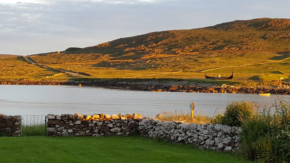 View of the Viking ship and house on a summer evening.