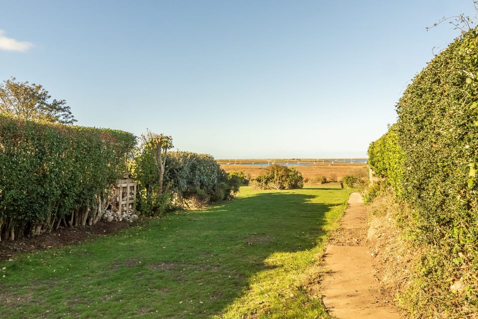 Extensive garden with marshes beyond