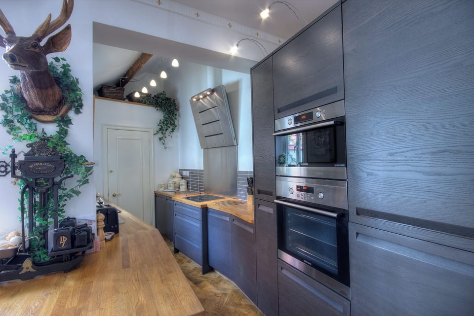 Breakfast bar leading into kitchen area equipped with high end appliances