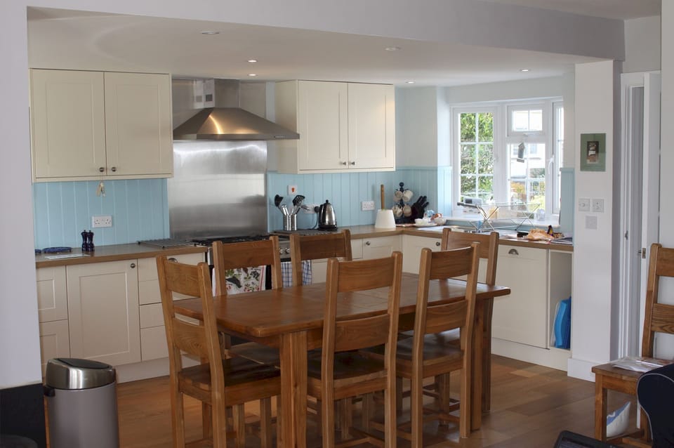 The dining table is within the kitchen/sitting room & extends to seat 8+ people.
