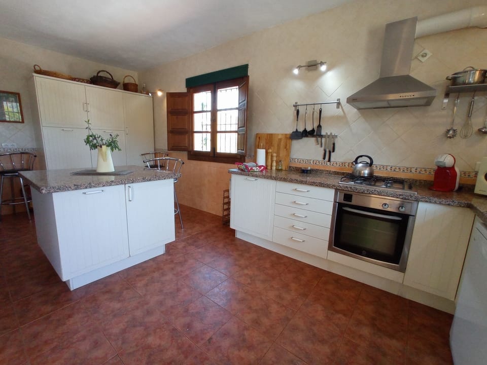 Very spacious and well equipped kitchen with preparaton island in middle.