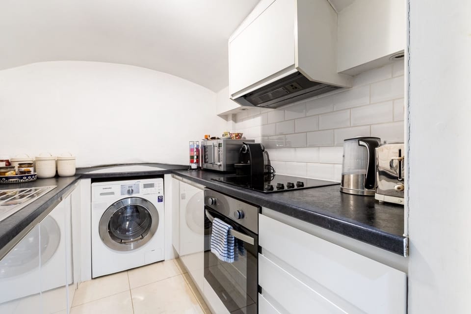 Kitchen with fridge, washer/dryer,  oven, hob and microwave and coffee machine