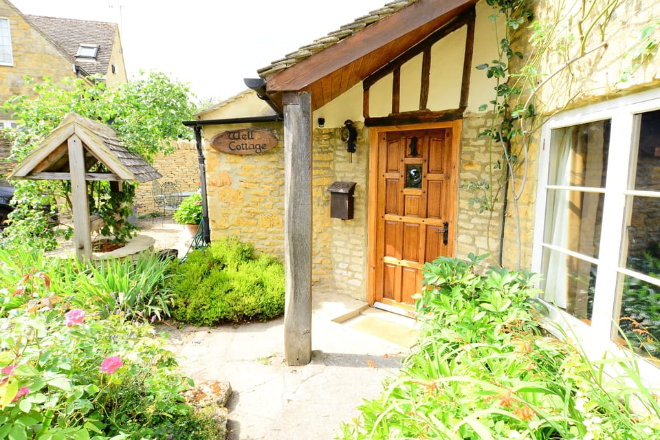 Welcome!
Oak front door to Well Cottage with canopy over the door.  