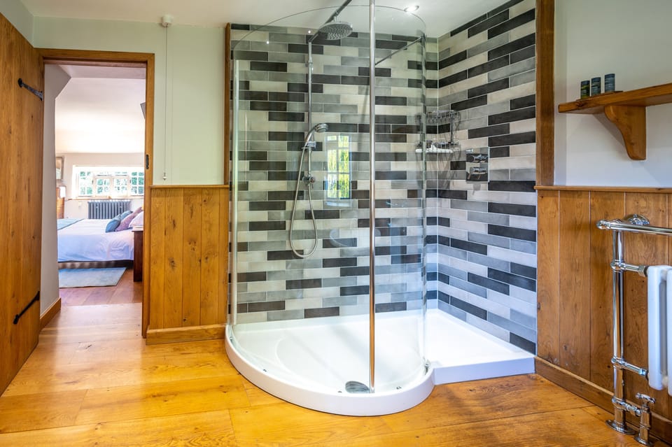 First floor:  Master bedroom en-suite bathroom with a shower
