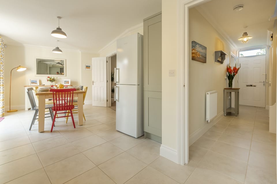Ground floor: Kitchen area with large fridge/freezer and door to hallway