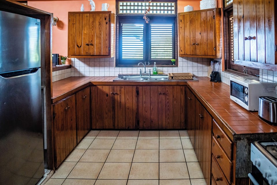 Kitchen with large fridge and all appliances you may need