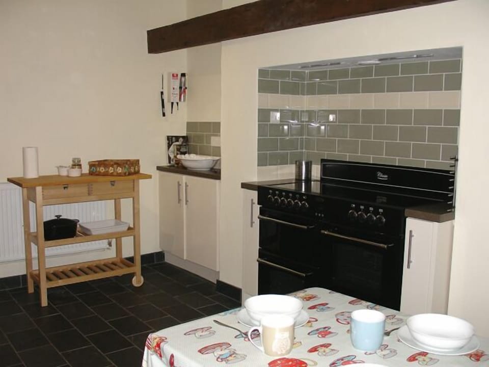 Spacious well-equipped modern kitchen retaining its oak beams