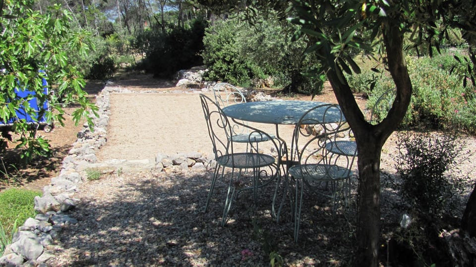 Boules Court and seating under the olive trees