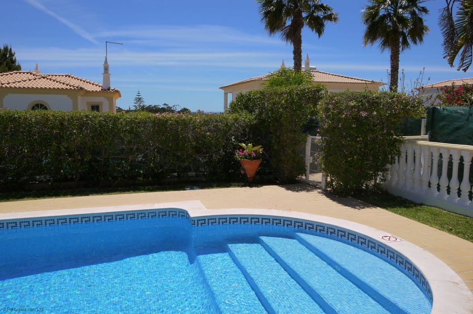 Estrelicia's very private pool surround with high shrubs, pretty garden & lawn & beautiful sea views.