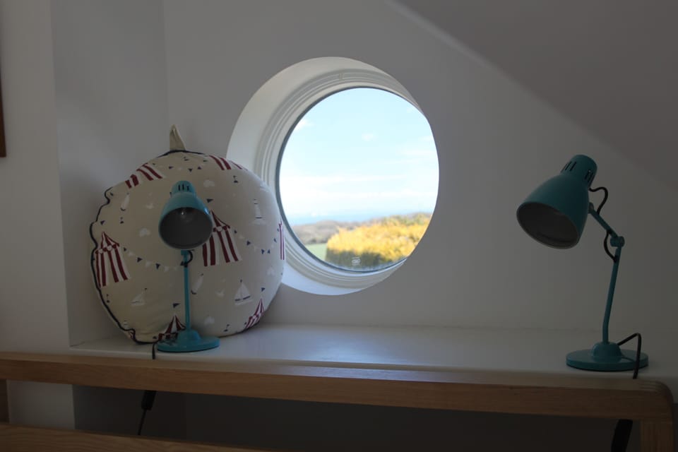 Porthole window with view of Isle of Wight.