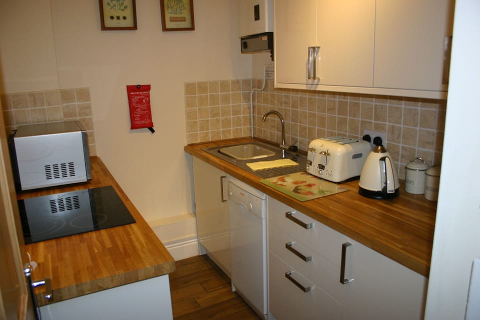 Kitchen with dishwasher and integrated fridge freezer