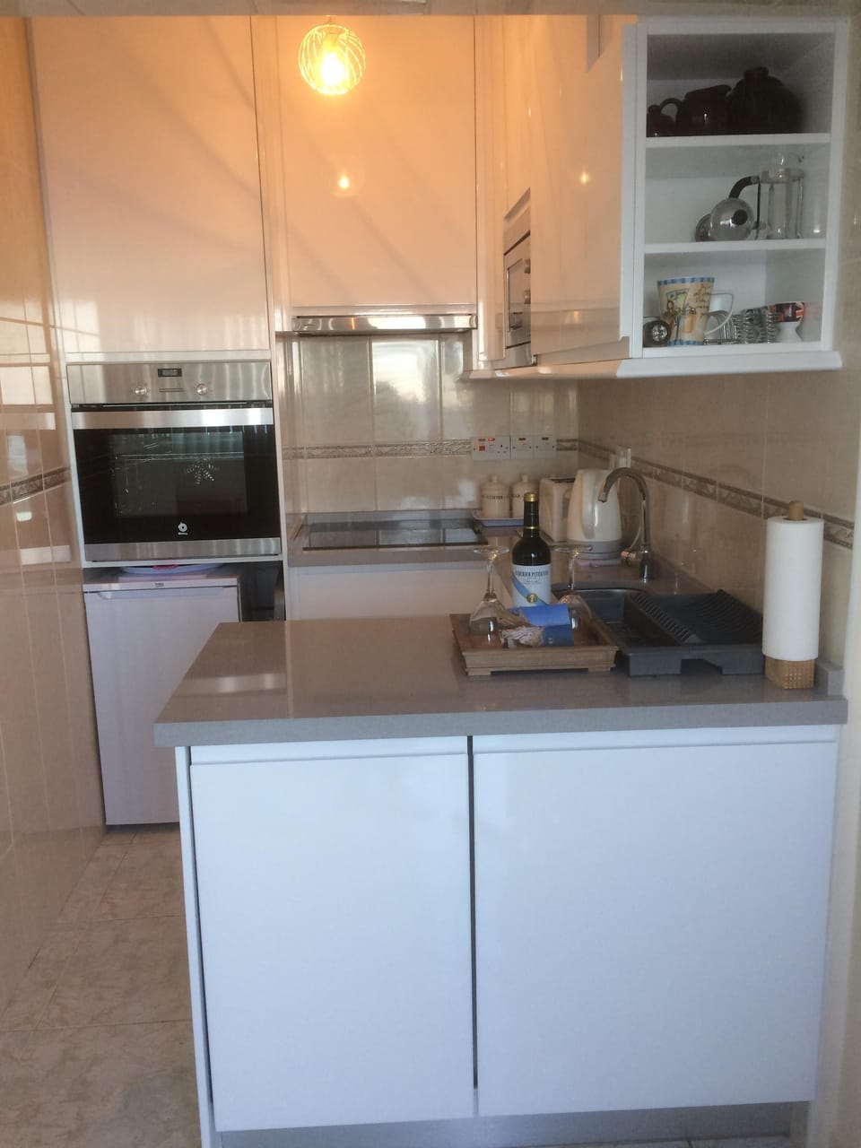 Modern kitchen with oven, hob, microwave, dishwasher and washing mach