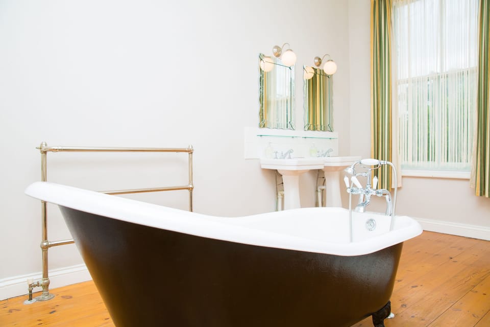 Master ensuite with roll top bath and separate shower