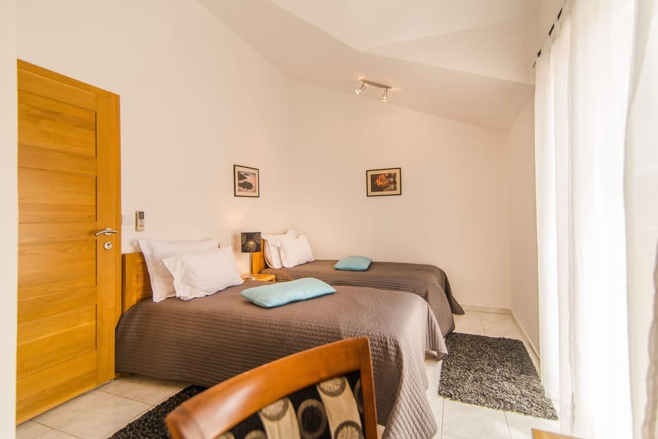 One bedroom with 2 single beds, shares a bathroom with a double room