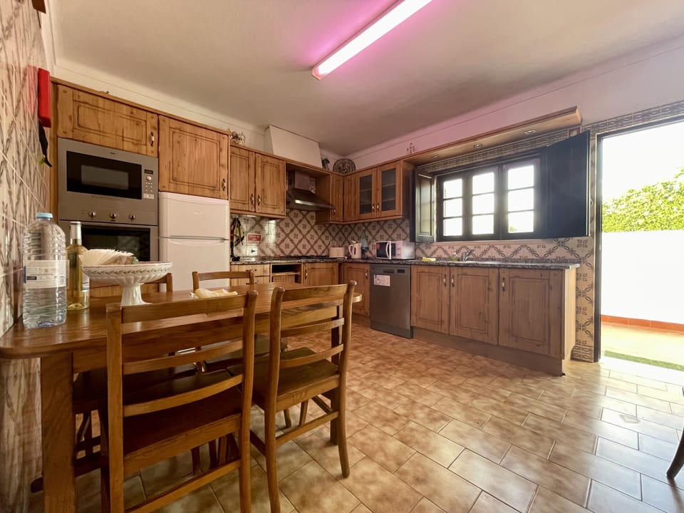 Villa Julia's Fully equipped, country style kitchen, with door to terrace with large, built-in BBQ, & laundry room. Located ddjacent to the lounge/dinner, complete with a breakfast table, oven & hob, dishwasher,  kettle, microwave, toaster and more..