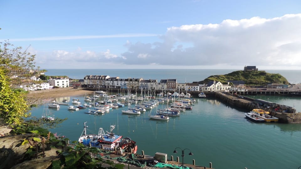 ILFRACOMBE HARBOUR WITH ST NICHOLAS CHAPEL ON THE HILL.