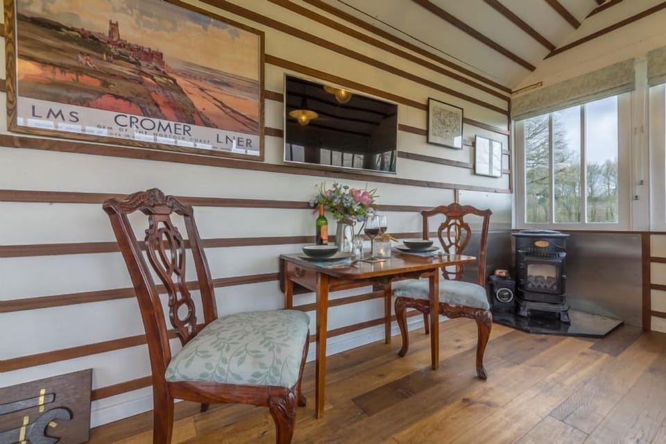 First floor:  Open-plan living space with table and seating for two
