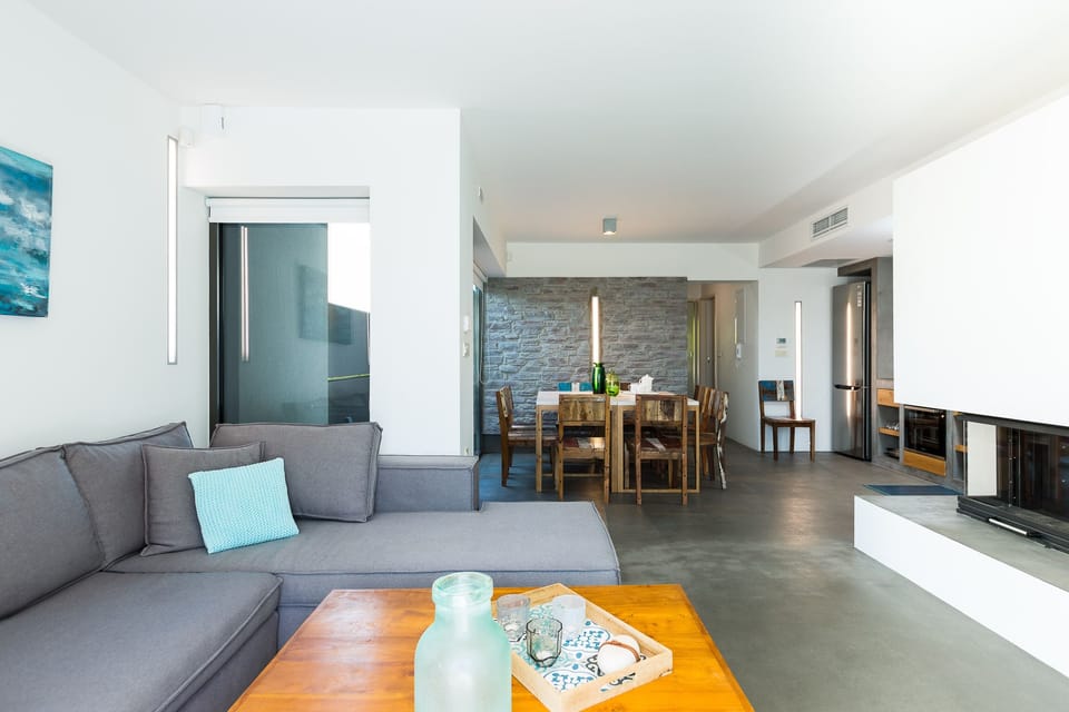 Living room with a large sofa, a fireplace, a 42” satellite HDTV