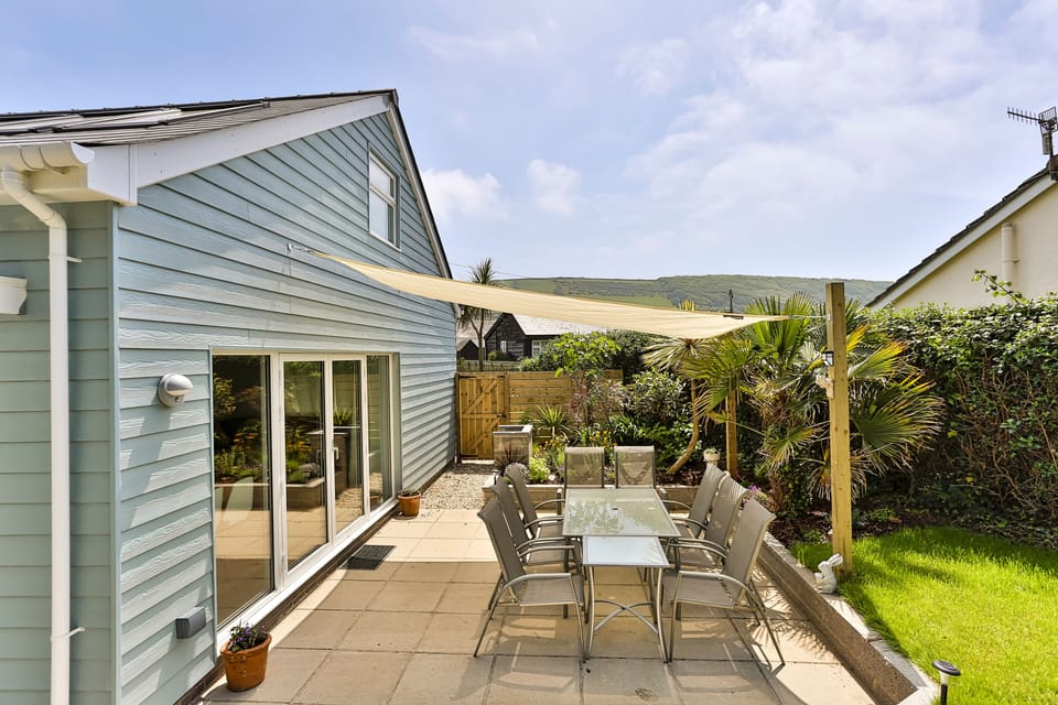 Patio with sun shade over tables and chairs