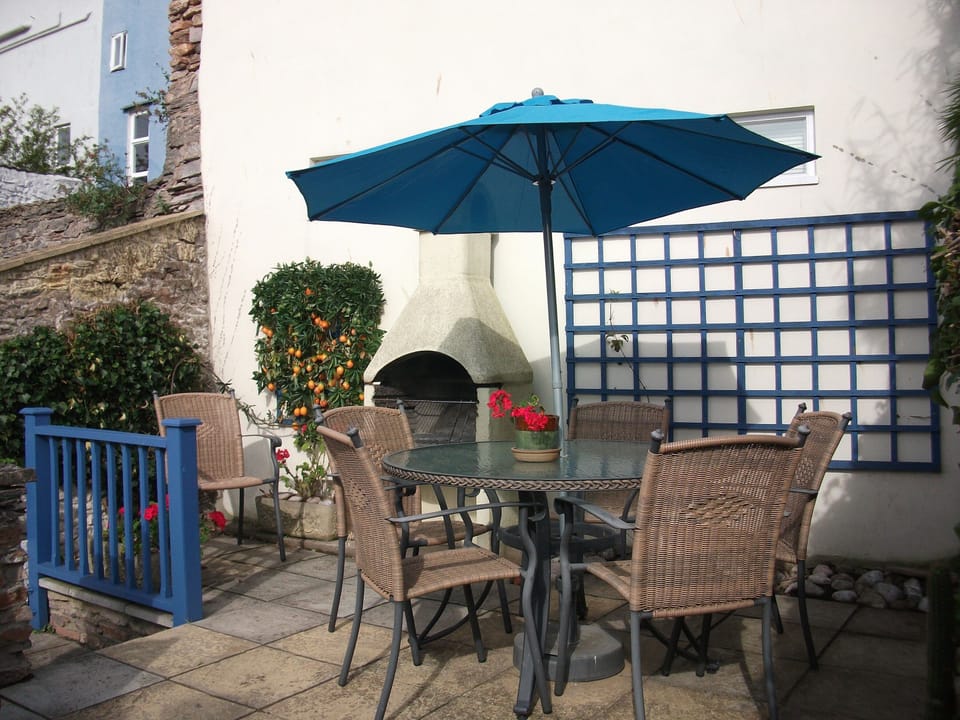 sunny rear patio accessed by steep steps