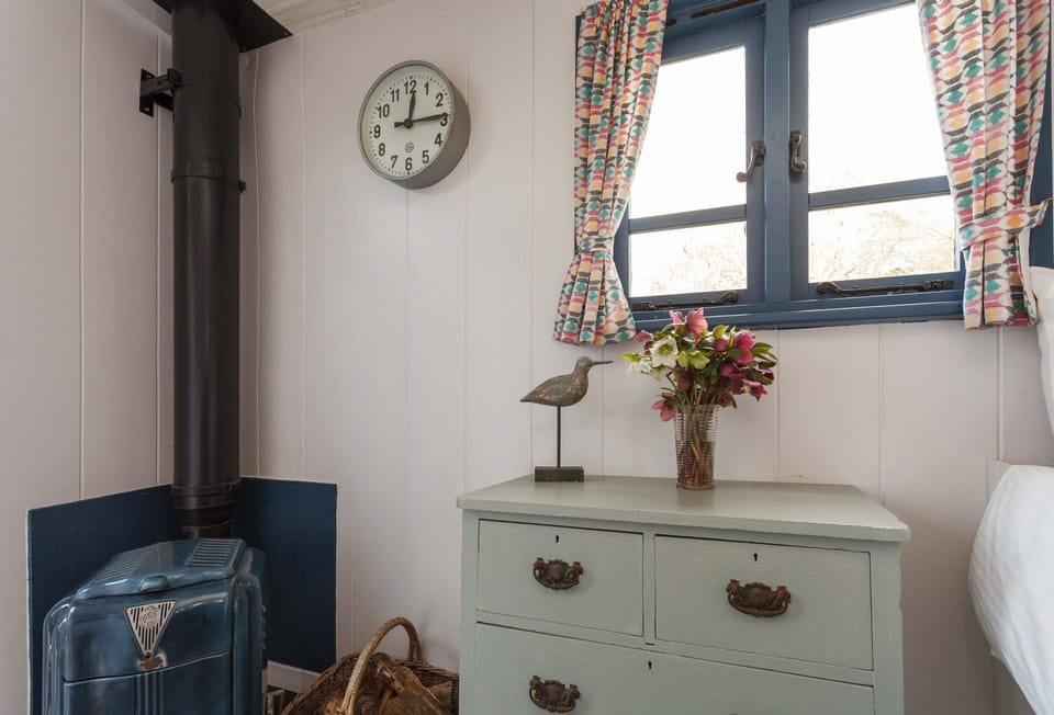 Plum Cottage: The wood burning stove, in the shepherds hut