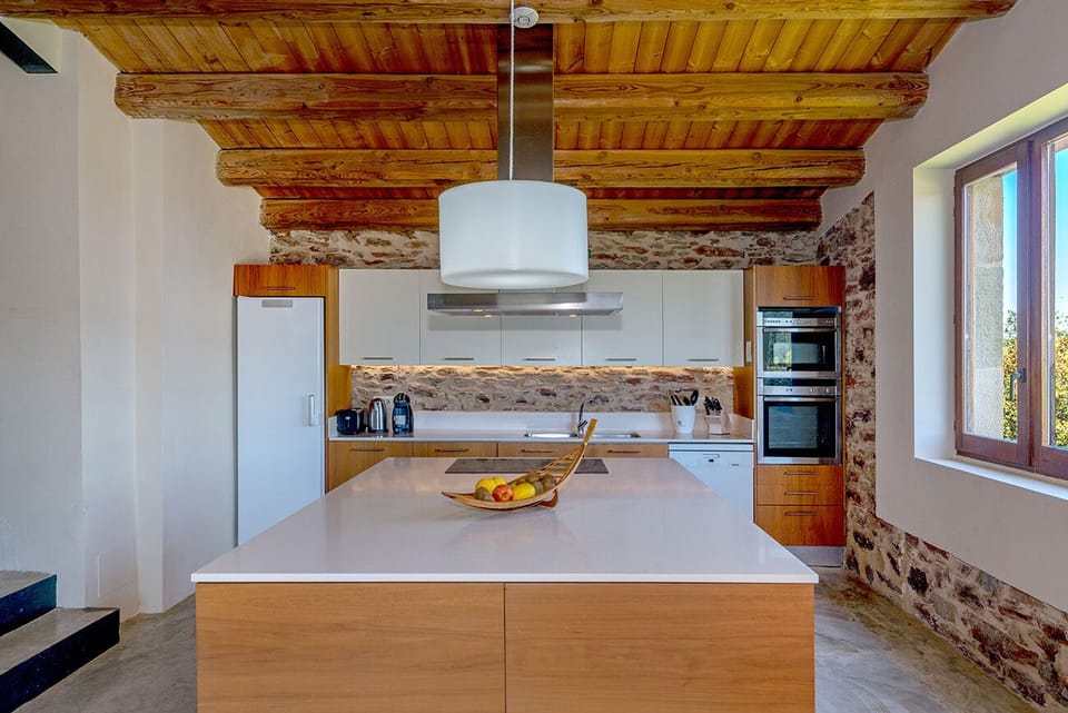 Fully equipped kitchen with adjacent pantry and utility room with 2 more fridges