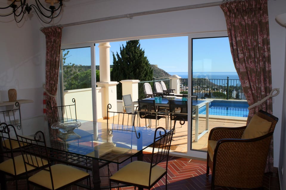 Dine inside or out, but both have lovely pool and sea views!