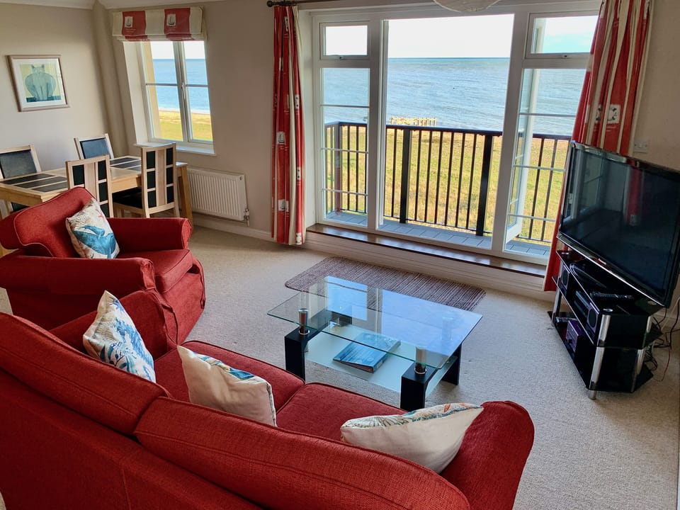Open-plan living and dining area with sea views
