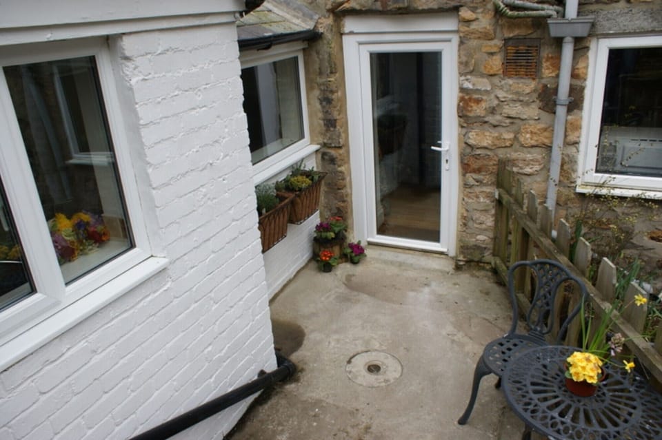 A secure outside space at the back of the cottage.