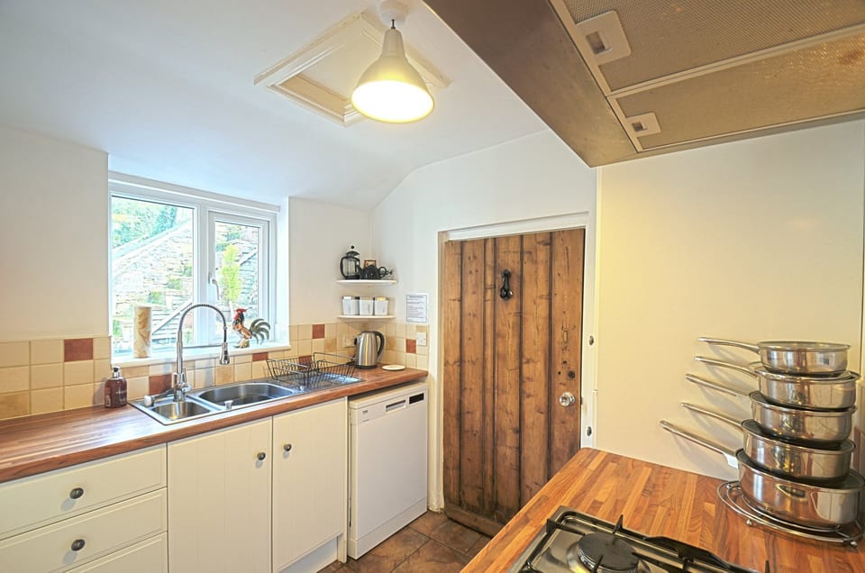 The modern country kitchen has full size fridge/freezer, oven, dishwasher....