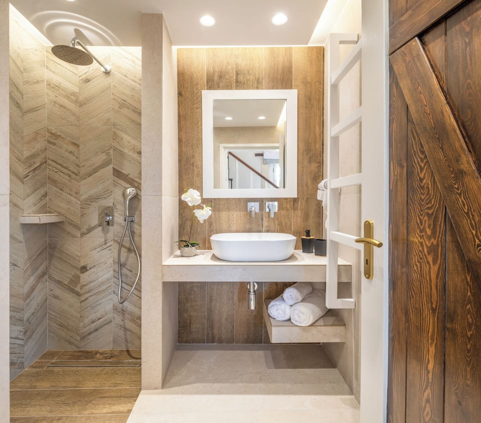 The bathroom features a walk in shower.